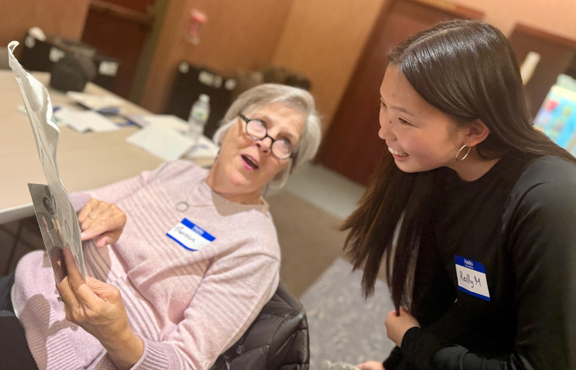 Sharing Stories Across Generations | Timeless Treasures Nyack Reilly Maier of Timeless Treasures Nyack listens as a lifelong learner shares a family photograph.